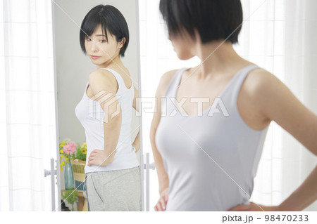 鏡で体型をチェックする女性 鏡で体型をチェックする女性 98470233