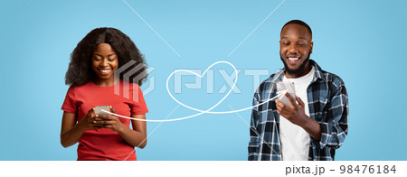 Dating Online. Romantic Black Couple Using Smartphones Connected With Heart Shape String 98476184