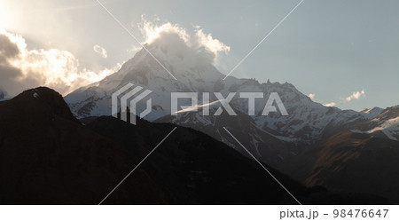 Mount Kazbek in the evening. Georgian mountain landscape Mount Kazbek in the evening. Georgian mountain landscape 98476647