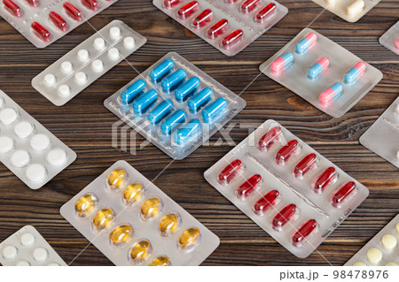too many different pill of various blisters with different pills Medicines storage at home concept Medication storing. A pile of medicine in blister packs. Pharmaceutical blister packs 98478976
