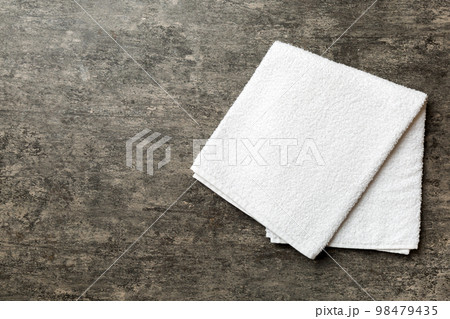 Top view of white towels with copy space on colored background 98479435