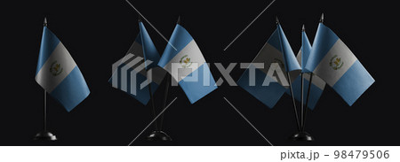 Small national flags of the Guatemala on a black background 98479506
