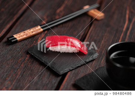 Delicious sushi maguro tuna. Nigiri with tuna on black and wooden background . Traditional Japanese cuisine 98480486