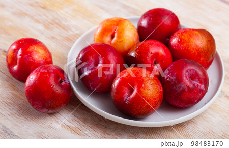 Fresh red plums in plate Fresh red plums in plate 98483170