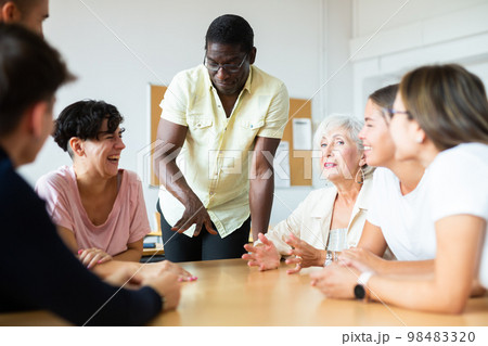 People of different ages communicating in speaking club with African American teacher People of different ages communicating in speaking club with African American teacher 98483320