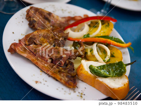 Image of tasty lamb baked and served with bread and vegetables Image of tasty lamb baked and served with bread and vegetables 98483510