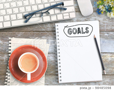 Top view with goals on notebook,keyboard,coffee and glasses on wood table 98485098