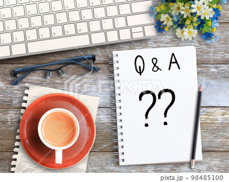 Top view with question mark on notebook in office workplace Top view with question mark on notebook in office workplace 98485100