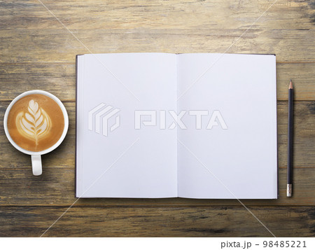 Office desk with blank notebook and coffee on wood table background. Office desk with blank notebook and coffee on wood table background. 98485221
