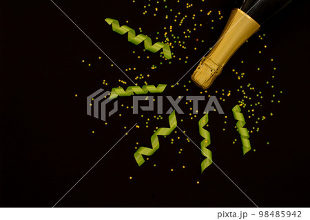 Champagne with party concept, Champagne bottle with ribbon and confetti stars on back background 98485942