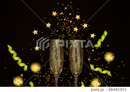 Champagne with party concept, Champagne glass with ribbon and gold ball with confetti colorful star Champagne with party concept, Champagne glass with ribbon and gold ball with confetti colorful star 98485955