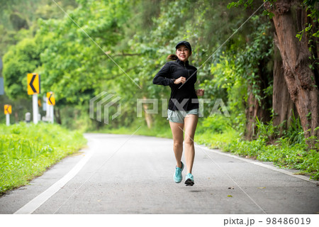 Healthy woman jogging run and workout on road outdoor 98486019