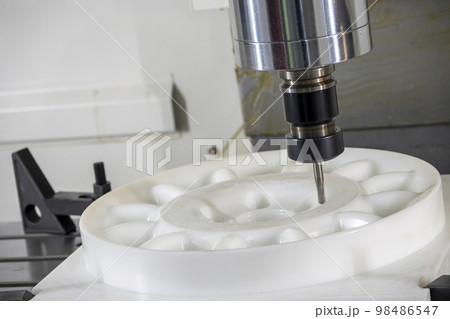 The  CNC milling machine cutting the nylon 6 material part with ball end mill tool. 98486547