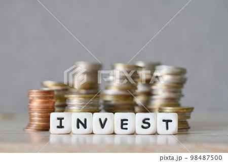 invest and a coin on wooden table background, invest business economy concept of money and finance investments 98487500