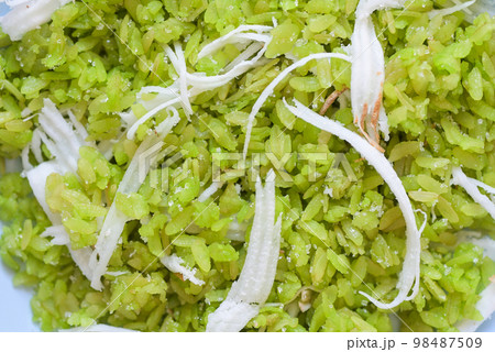 Thai dessert - pounded unripe rice food rice flakes cereal with coconut and sugar, Green rice sweet with ears of rice pandan leaf, Food dessert or snacks - Khao Mao name in Thailand 98487509