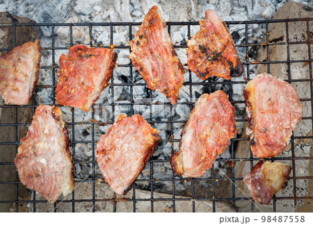 Grilled pork steaks, pork neck with salt on the grill nature local food rural asia, Grilled meat bbq barbecue pork roast street food 98487558