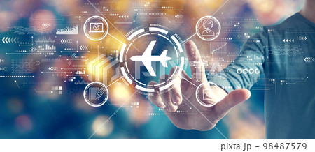 Flight ticket booking concept with man on blurred city light background 98487579