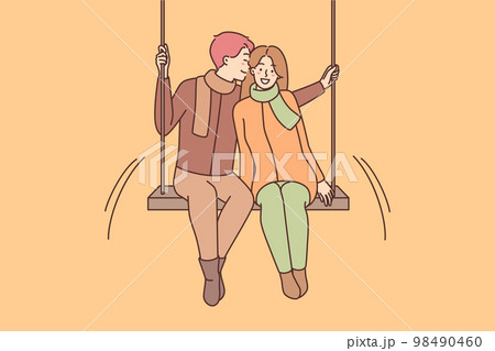 Happy couple on swing in park  98490460