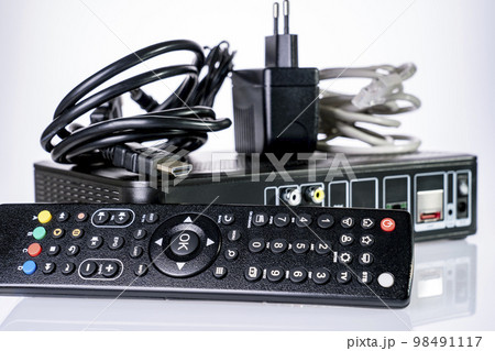 TV set-top box prepared for installation, digital TV kit on white background close-up with reflection TV set-top box prepared for installation, digital TV kit on white background close-up with reflection 98491117