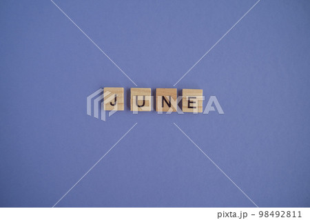 The sixth month of the year June - from isolated letters on wooden blocks in natural color, in high resolution. Very Peri Color of the Year background, copy space. Flat lay, step by step, step 6. 98492811