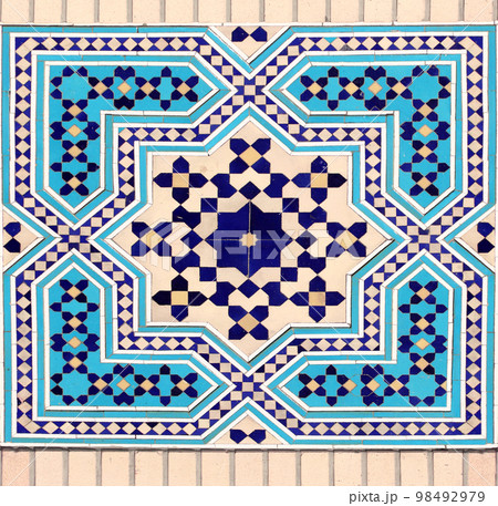 Detail of persian mosaic wall with geometric ornament of blue, dark blue and yellow color, Iran 98492979