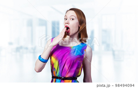 Surprised young female model with red hair Surprised young female model with red hair 98494094