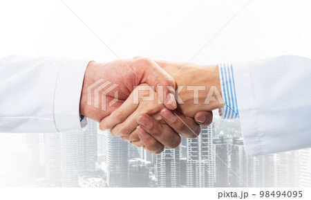 Close-up of the handshake between the two medics 98494095