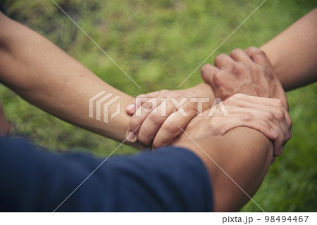 Close up three hands Diverse multiethnic Partner team together. Teamwork group of multiracial people meeting join hands together. Diversity people hand join empower partner team trust team solidarity Close up three hands Diverse multiethnic Partner team together. Teamwork group of multiracial people meeting join hands together. Diversity people hand join empower partner team trust team solidarity 98494467