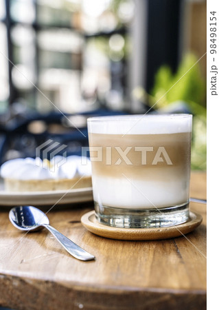 Coffee and cake on a cafe table outside. Morning, drink, good mood concept 98498154
