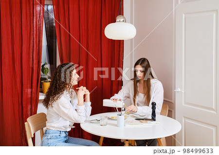 Woman sharing with her friend about tricks of healthy food that is easy to cook at home Woman sharing with her friend about tricks of healthy food that is easy to cook at home 98499633