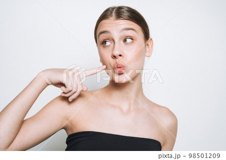 Beauty portrait of funny young girl with fresh skin tone showing kiss on white background isolated 98501209