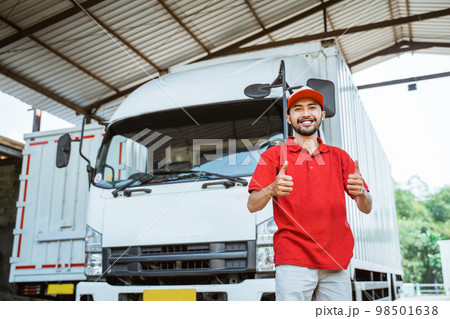 delivery man driver with thumbs up in front of truck 98501638