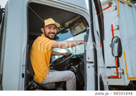 male worker closes the door of a freight truck male worker closes the door of a freight truck 98501948