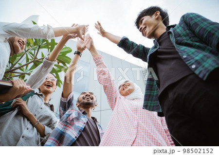 students enthusiastically raised their hands as a sign of unity 98502152