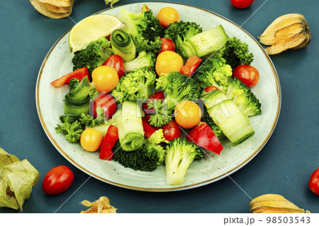 Spring raw salad decorated with physalis. 98503543