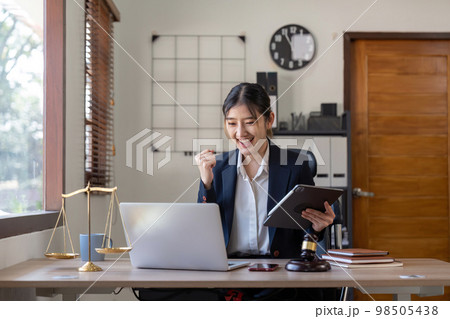 Asian business lawyer are excited about celebrating business success with inspiration from their excellent financial results that are happy working in a modern office on a computer Asian business lawyer are excited about celebrating business success with inspiration from their excellent financial results that are happy working in a modern office on a computer 98505438