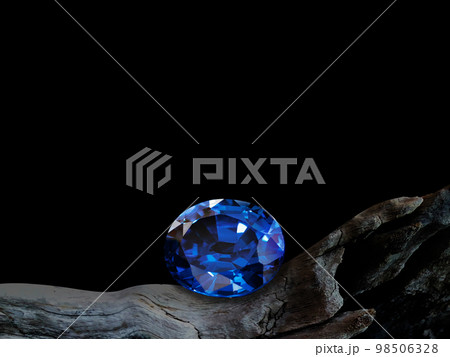 blue sapphire on old wooden with black background 98506328