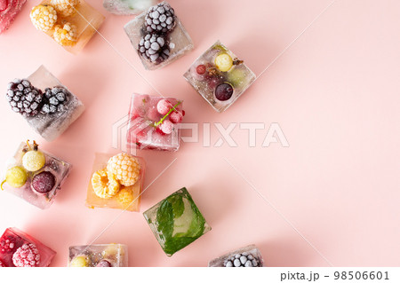 Frozen ice cubes with various berries Frozen ice cubes with various berries 98506601
