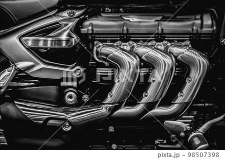Motorcycle engine. Closeup superbike engine exhaust pipes art photography in black and white vintage 98507398