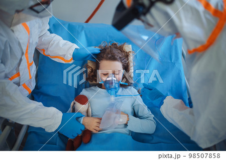 Close-up of little girl with infection disease lying in hospital room. 98507858