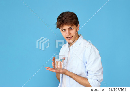 Young handsome man with drinking glass of water 98508561