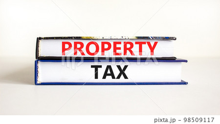 Property tax symbol. Concept words Property tax on books. Beautiful white table white background. Business and property tax concept. Copy space. Property tax symbol. Concept words Property tax on books. Beautiful white table white background. Business and property tax concept. Copy space. 98509117