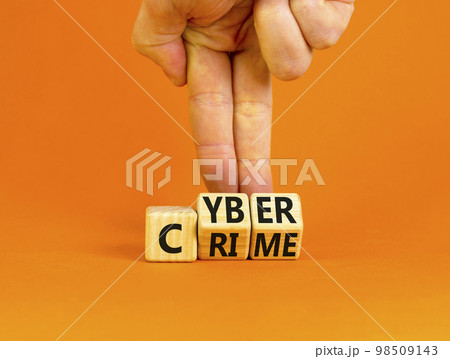 Cyber crime symbol. Concept words Cyber crime on wooden cubes. Businessman hand. Beautiful orange table orange background. Business and cyber crime concept. Copy space. Cyber crime symbol. Concept words Cyber crime on wooden cubes. Businessman hand. Beautiful orange table orange background. Business and cyber crime concept. Copy space. 98509143