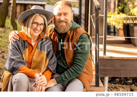 Man and woman sitting close and looking in love Man and woman sitting close and looking in love 98509715