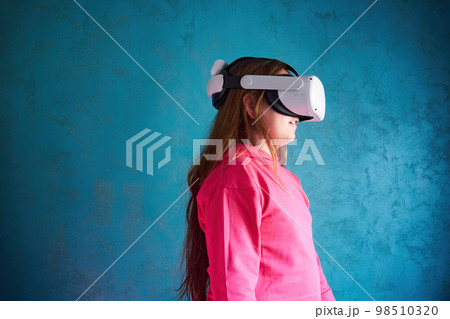 little girl playing with VR glasses little girl playing with VR glasses 98510320