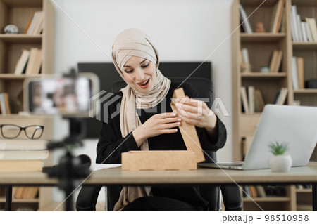 Arab woman using smart phone camera for creating content. Arab woman using smart phone camera for creating content. 98510958