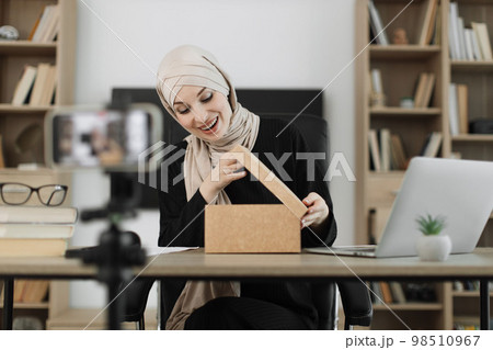 Arab woman using smart phone camera for creating content. 98510967