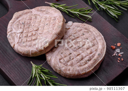 Raw meat balls with spices and herbs or crepinette 98511307