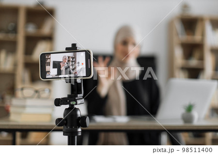 Female tutor working at home during distance learning and showing thumb up. 98511400