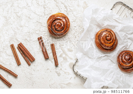 Freshly baked homemade Cinnamon rolls or Cinnamon buns on baking paper Freshly baked homemade Cinnamon rolls or Cinnamon buns on baking paper 98511766